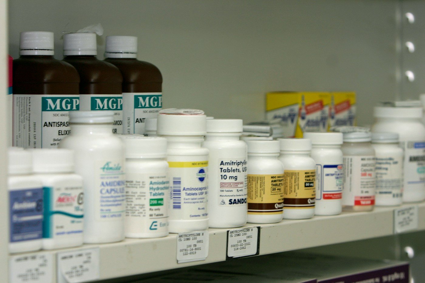 Shelves stocked with a wide range of packaged medicines